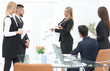 © ASDF - business woman doing a presentation to his business team.