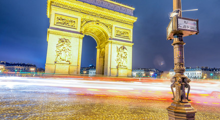 Poster - Traffic around Triumph Arc at night in Paris - France