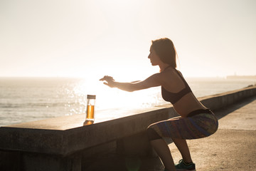 Fit woman doing exercices on summer sunset