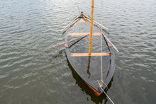 Wooden Sailboat On The Sea, Water Inside. Boat Under Water.