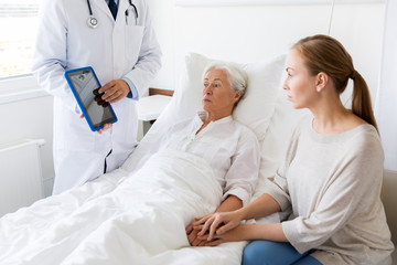 Poster - senior woman and doctor with tablet pc at hospital