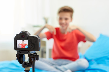 Wall Mural - camera recording video of blogger boy at home