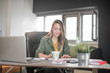 © Milica - Young woman working at home on computer