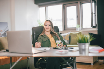 Wall Mural - Young woman working at home