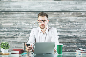 Wall Mural - Concentrated businessman using device at workplace