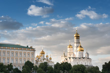 The Bell Tower Of Ivan The Great And The Annunciation Cathedral In The Moscow Kremlin. Grand Palace And Church Against The Background Of A Cloudy Sky
