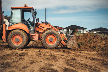 Wall Mural - Industrial machinery at construction site. Close up of backhoe loader working