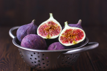 Fresh ripe figs at metal colander.