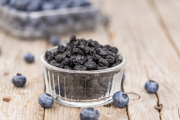 Wall Mural - Dried Blueberries on wooden background; selective focus