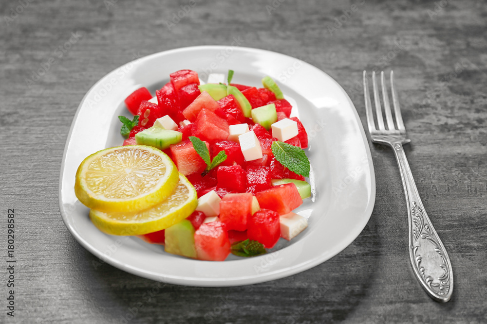 Plate with delicious watermelon salad on table