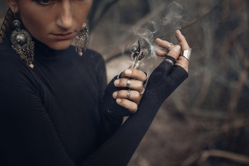 Wall Mural - close up of young woman hands holding incense