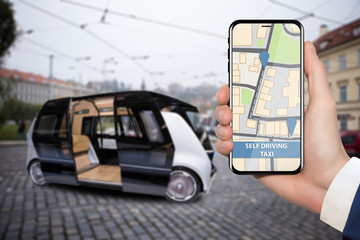 Control of self driving bus by mobile app. Hand with phone on a background of autonomous vehicle with open door.