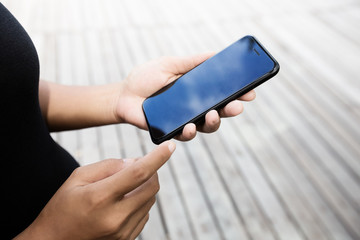 Aufkleber - close-up on woman hand using phone outdoor lifestyle