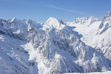 Winter mountains with high peaks.