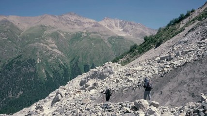 Wall Mural - alpinists hiking on snow mountain. tourist group climbing a snow mountain peak