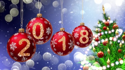 Wall Mural - red balls with numbers 2018 hanging on the background of a blue bokeh and a rotating christmas tree 
