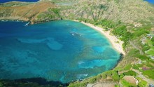 Aerial: Hanauma Bay Nature Preserve, Blue-Green Water Hawaiian Ocean Cove.  Tourist Location For Snorkeling On Coral Reef With Tropical Fish In Oahu Island, Hawaii.  Watersport For Ocean Adventurers