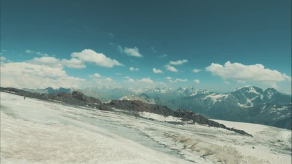 Wall Mural - beautiful scene tourists walking on snow mountain. winter hiking in mountain