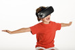 © javiindy - Little girl looking in VR glasses and gesturing with his hands.