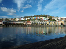 Bristol`s Harbourside And The Colourful Houses Reflecting In The River