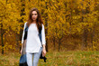 © milogrodskiy - Young girl with long brow hair in autumn park