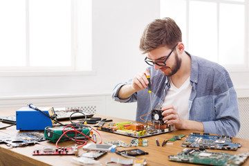 Poster - Repairman disassemble motherboard with screwdriver