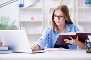 Wall Mural - Young teenage female student preparing for exams at home