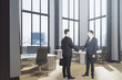 © Who is Danny - Businessmen shaking hands in office