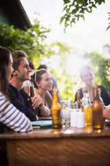 Students having fun while they prepare a bbq and drinking beers