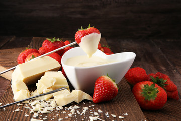 Wall Mural - Chocolate fondue melted with fresh strawberries and white chocolate pieces.