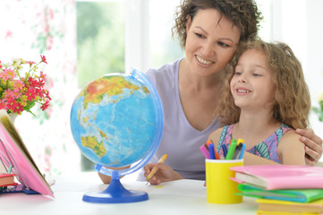 Wall Mural - mother helping her  daughter with homework