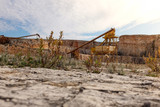 Fototapeta Konie - Former stone quarry with abandoned crusher and conveyor machines. Apulia region, Italy.
