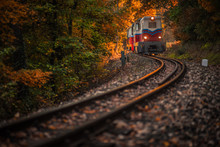 Budapest, Hungary - Beautiful Autumn Forest With Foliage And Old Colorful Train Coming Out Of Tunnel In Hungarian Woods At Sunset