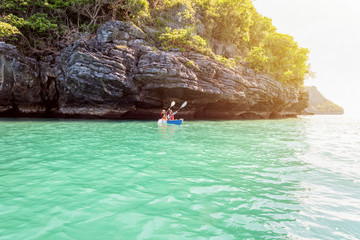 Two women are mother and daughter. Travel by boat with a kayak under sunlight at summer around Ko Phi, beautiful nature of the sea and island, Mu Ko Ang Thong National Park, Surat Thani, Thailand