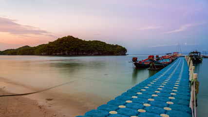 Wall Mural - Floating bridge pier for tourist on the beach in front of Ko Wua Ta Lap island view Ko Phi during sunset at Mu Ko Ang Thong National Marine Park in Gulf of Thailand, Surat Thani province