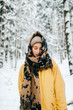 © benevolente - Lovely girl with angelic beautiful face. Odd bizarre person. Kinky female in winter snowy forest freezing and covering with warm clothing. Emotional lady eyes looking. Happy smiling blonde traveler.