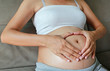© zilvergolf - Pregnant Woman hands in a heart shape on her belly.