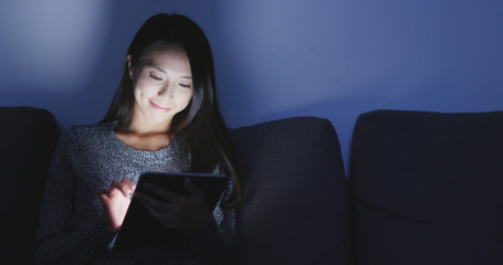 Wall Mural - Woman use of digital tablet computer at home in night time