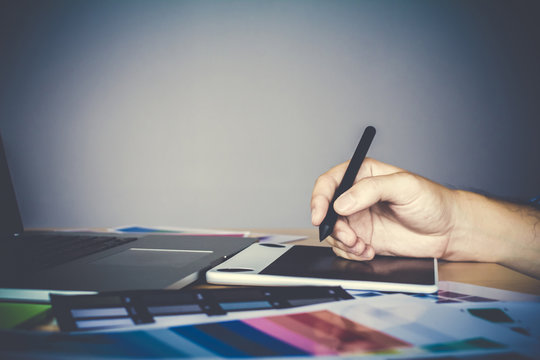 Designer graphic creative  working on Mouse pen,laptop in  office