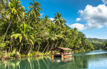 Traditional Raft Boat With Tourists On A Jungle Green River Loboc At Bohol Island Of Philippines