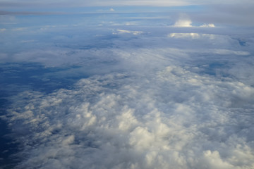 Wall Mural - view of beautiful abstract soft white cloudscape with shades of blue sky background from flying plan