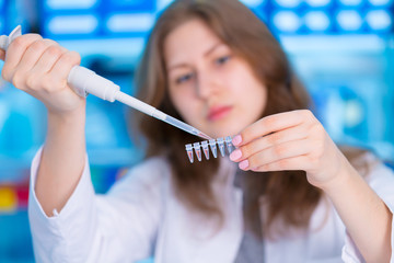 Canvas Print - laboratory female assistant with pipette