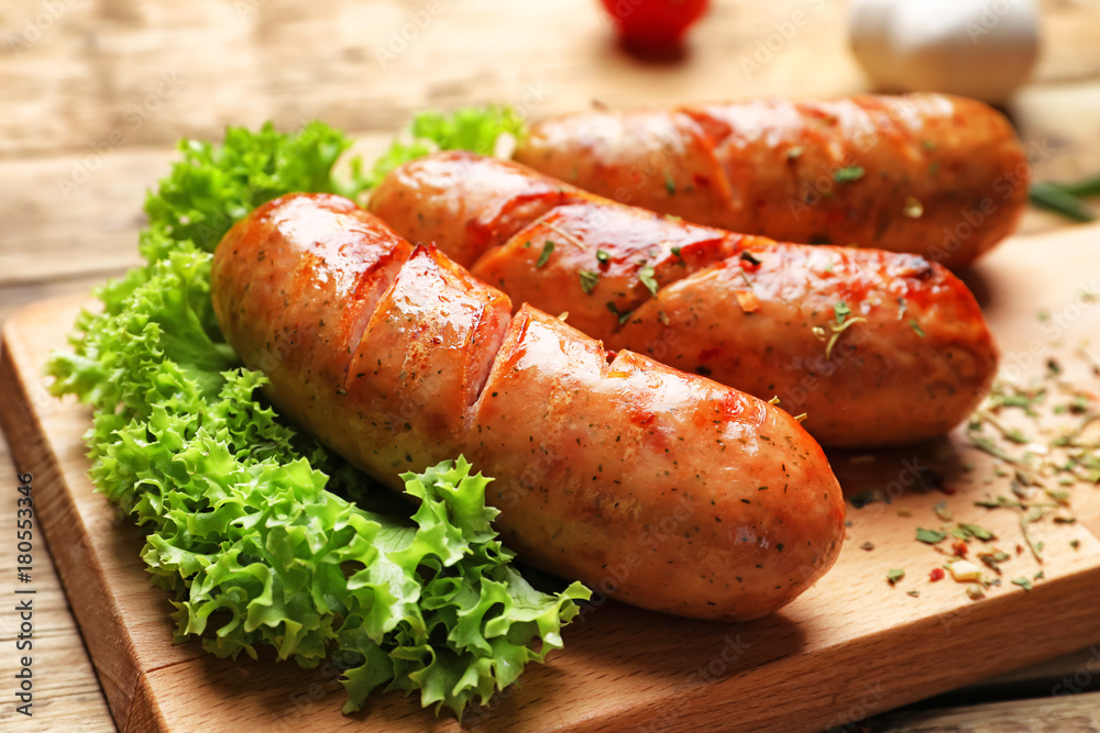 Grilled sausages on wooden board