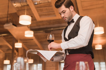 Wall Mural - waiter serving wineglasses on table