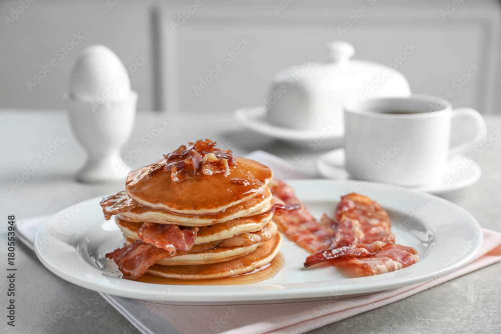 Tasty pancakes with bacon on plate