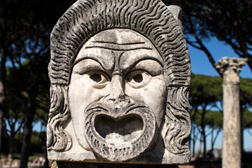 Marble Mask decoration in Ostia Antica theatre. Ancient Rome 1st century mask in the proscenium of Ostia antica, part of architectonic decoration