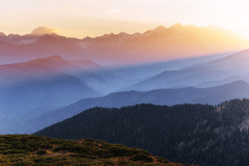 Wall Mural - Sunset over snow-capped mountain peaks. The view from the mountains to Mount Ushba Mheyer, Georgia. Europe