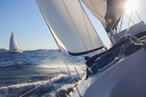Sailing in the wind through the waves, yachts at sailing regatta