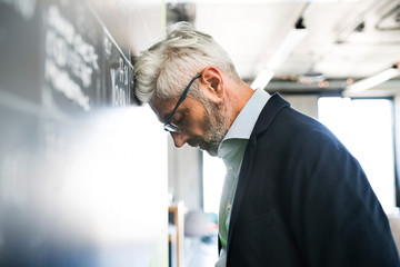 Wall Mural - Worried mature businessman in the office.