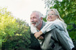 © Tijana - Happy senior couple smiling outdoors in nature, having fun
